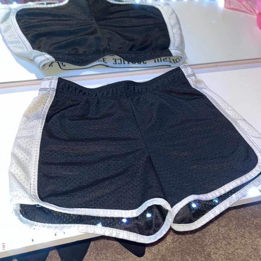 Justice black shorts, white stripes on side